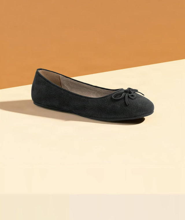ARIA ballet flat in black nubuck on a warm studio backdrop