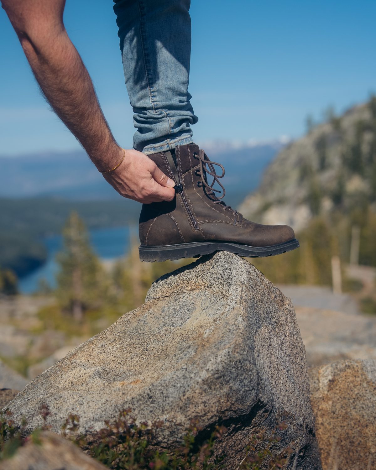 Lacing a REGENT boot on a mountain rock