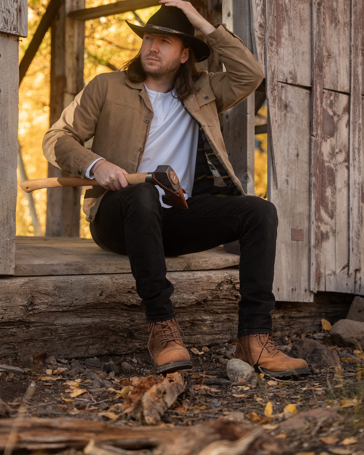 KING boots in Sunset Wheat Brown at an old cabin among fall aspens