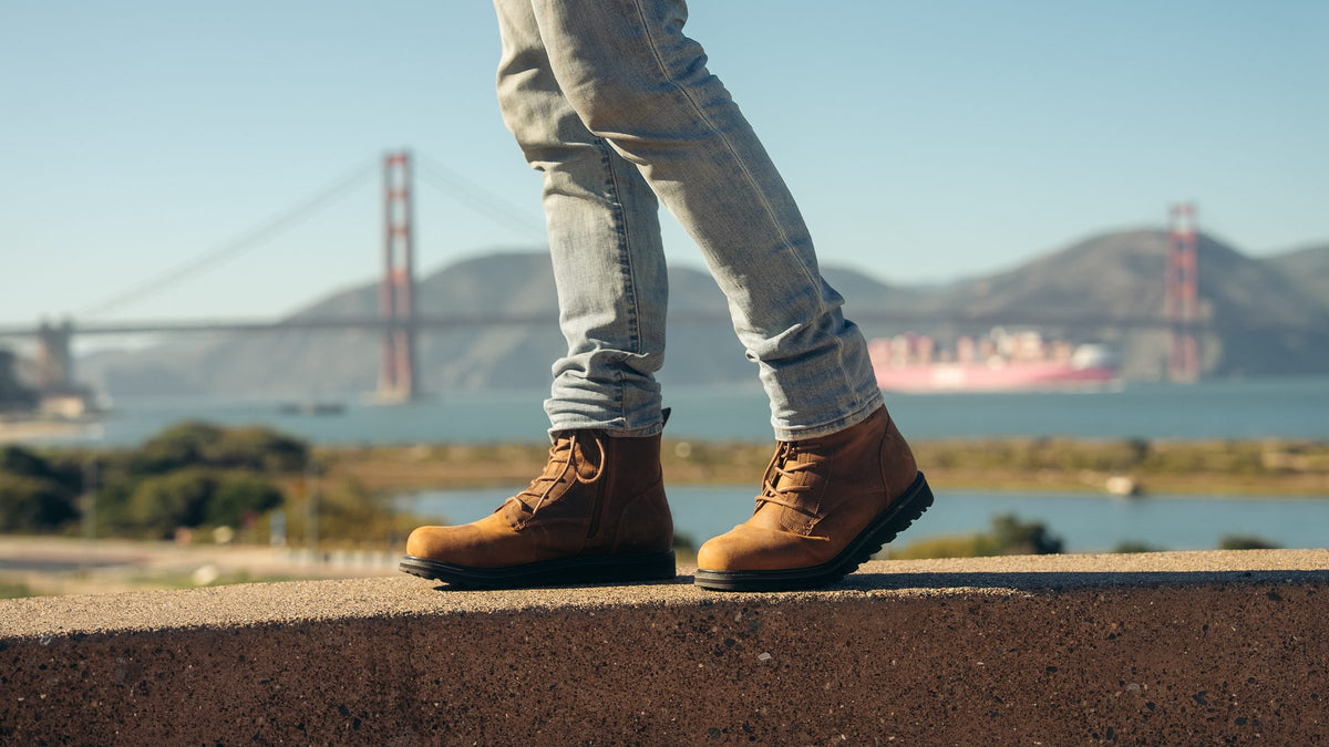 KING boots in Sunset Wheat Brown on a ledge above the Golden Gate Bridge