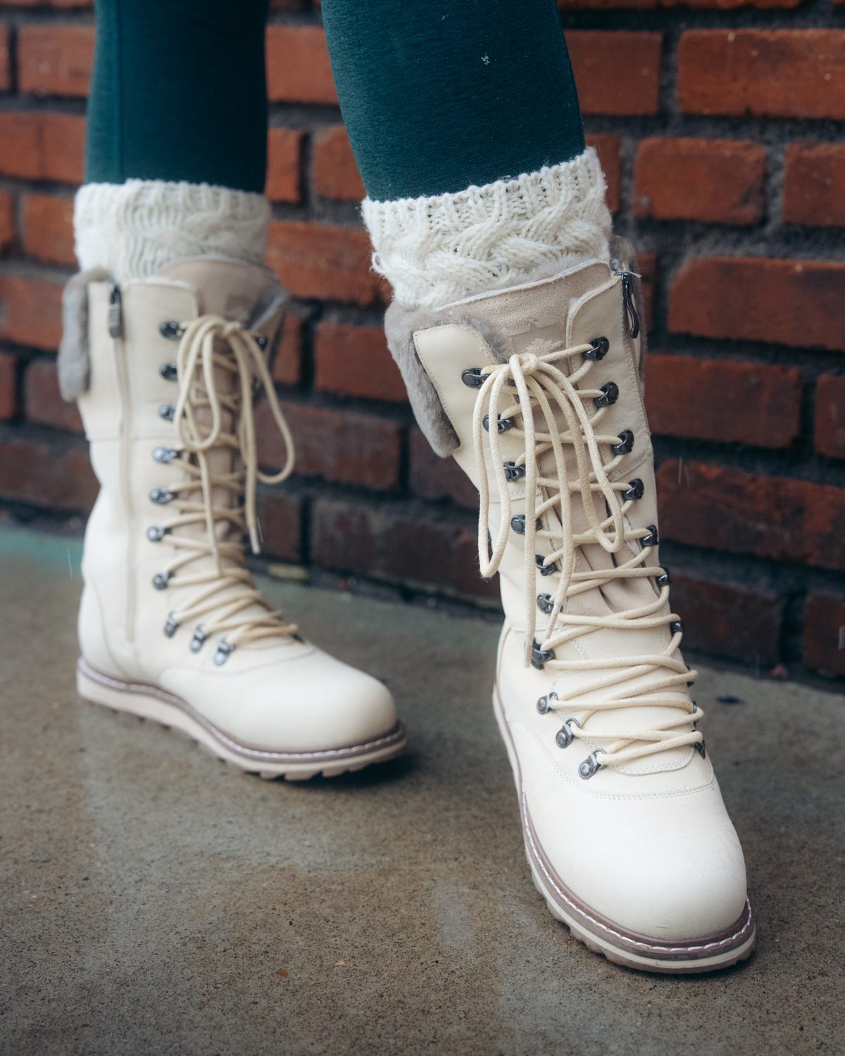 CASTLEGAR in Pale Ale White with knit socks against a brick wall